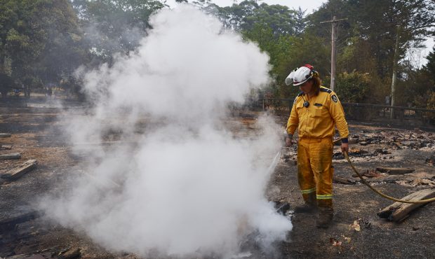 WINGELLO, AUSTRALIA - JANUARY 06: An RFS Crew attempts to put out a smoldering pile of railway slee...