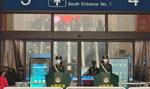 Guards wearing face masks stand at Hankou Railway Station on January 22, 2020 in Wuhan, China. A ne...
