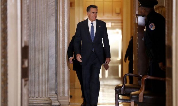Sen. Mitt Romney (R-UT) heads back into the Senate Chamber following a break in President Donald Tr...