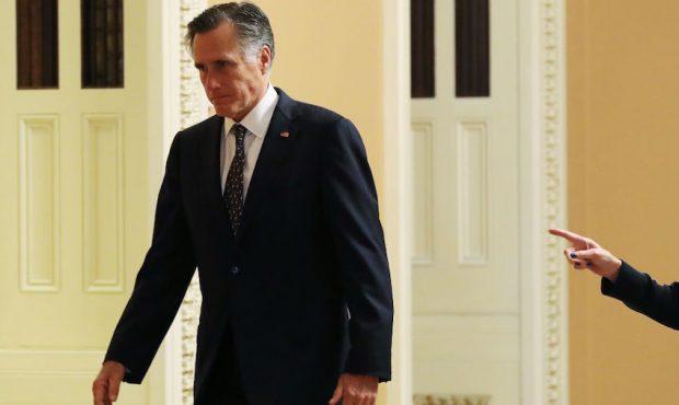 Sen. Mitt Romney (R-UT) walks outside the Senate chamber during a recess in the impeachment trial p...