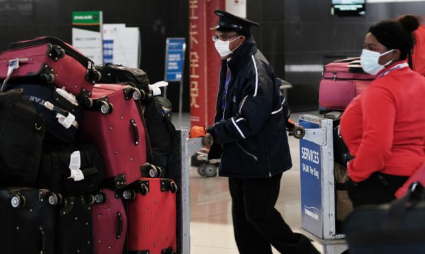 At the terminal that serves planes bound for China, people wear medical masks out of concern over t...