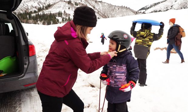 Alicia Hodges makes sure each of her four children are wearing a helmet before they go sledding....