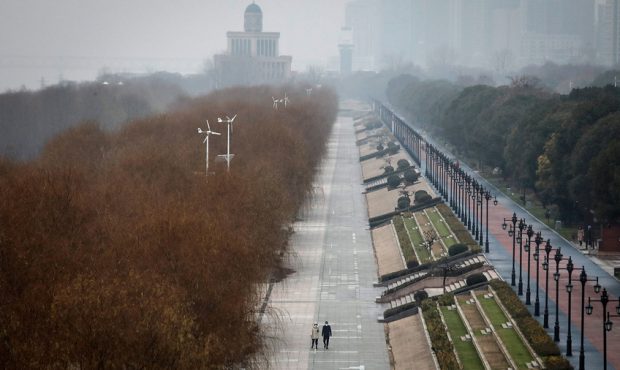 Two residents walk in an empty Jiangtan park on January 27, 2020 in Wuhan, China. As the death toll...