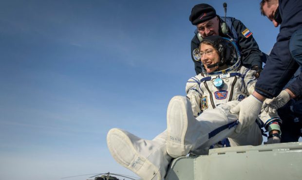 NASA astronaut Christina Koch is helped out of the Soyuz MS-13 spacecraft just minutes after she, R...