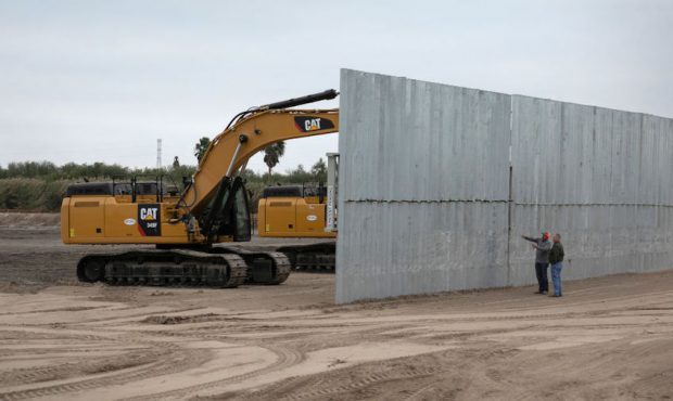 FILE: A construction crew works on a section of privately built border wall on December 11, 2019 ne...