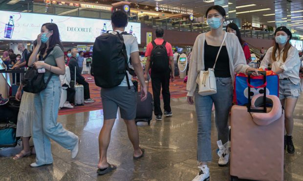 Visitors wearing masks arrive at the departure hall of Changi Airport on Jan. 25, 2020 in Singapore...