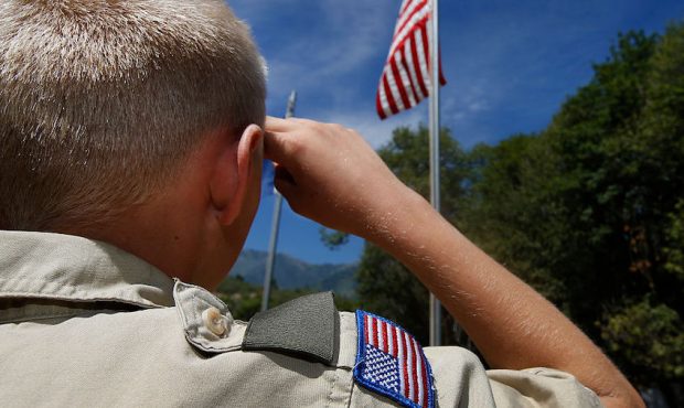FILE: A Boy Scout salutes the American flag at camp Maple Dell on July 31, 2015 outside Payson, Uta...