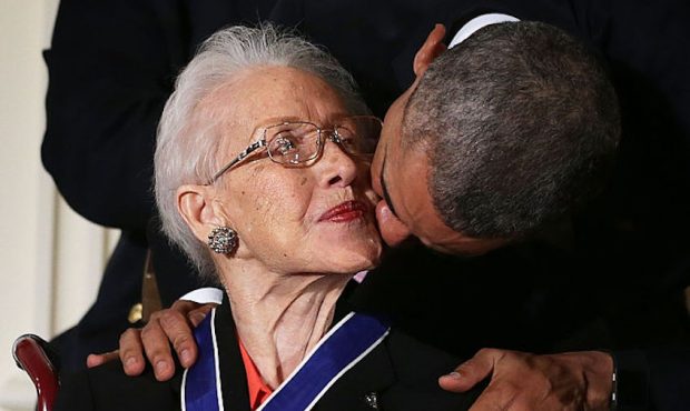 U.S. President Barack Obama kisses former NASA mathematician Katherine G. Johnson after he presente...