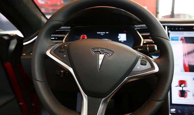 FILE: The inside of a Tesla vehicle is viewed as it sits parked in a new Tesla showroom and service...