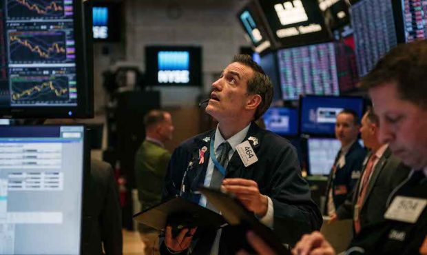 Traders work through the closing minutes of trading Tuesday on the New York Stock Exchange floor on...