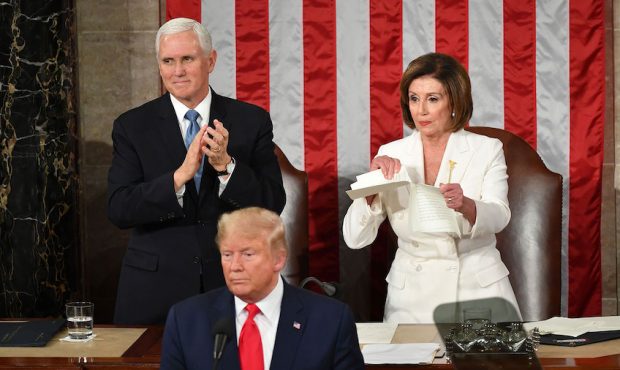US Vice President Mike Pence claps as Speaker of the US House of Representatives Nancy Pelosi rips ...