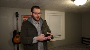Austin Jones uses his phone to program his wake-up lights so he doesn't struggle to get out of bed the next morning.