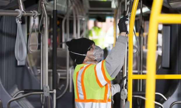 Tyler Goodwin, a utility service worker for King County Metro Transit, deep cleans a bus as part of...