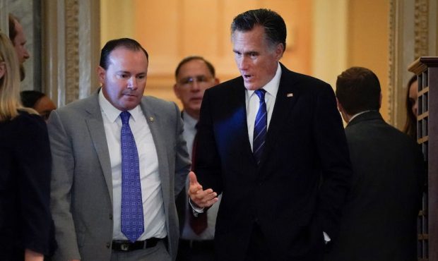 FILE: (L-R) Sen. Mike Lee (R-UT) and Sen. Mitt Romney (R-UT) talk as they arrive at the Senate cham...