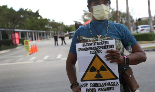 Odalys K. Fernandez holds a sign reading, "Caution!! Coronavirus risk at Miramar Ice cage", as she ...