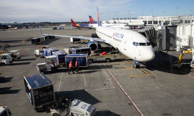 FILE: A ground crew prepares to unload luggage from an arriving Delta Airlines flight at the Seattl...