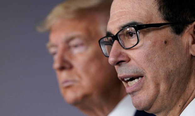 Treasury Secretary Steven Mnuchin (R) speaks while flanked by U.S. President Donald Trump during a ...