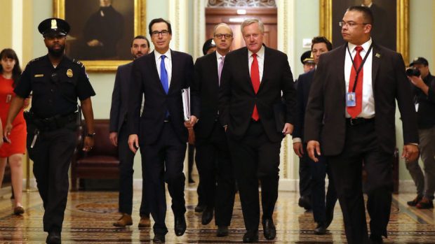 Treasury Secretary Steven Mnuchin (2L), White House Director of Legislative Affairs Eric Ueland (3L) and White House Chief of Staff Mark Meadows (4L) arrive at the U.S. Capitol to continue negotiations on a $2 trillion economic stimulus in response to the coronavirus pandemic March 24, 2020 in Washington, DC. After days of tense negotiations -- and Democrats twice blocking the nearly $2 trillion package -- the Senate and Treasury Department appear to have reached important compromises on legislation to shore up the economy during the COVID-19 pandemic. (Photo by Chip Somodevilla/Getty Images)