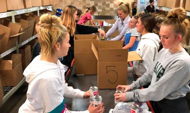 Volunteers pack boxes of food at the Utah Food Bank on Saturday, March 14, 2020. Officials say the ...