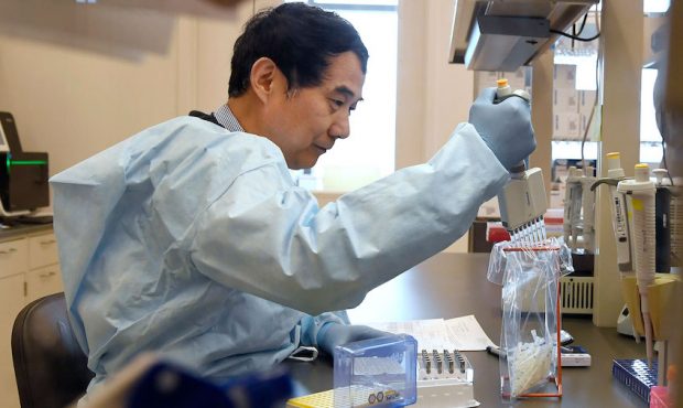 Microbiologist Xiugen Zhang runs a Polymerase Chain Reaction (PCR) test at the Connecticut State Pu...