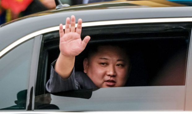 FILE: Kim Jong-un waves from his car after arriving by train at Dong Dang railway station near the ...
