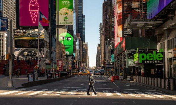 FILE: A police officer crosses the street in a nearly empty Times Square on March 12, 2020 in New Y...