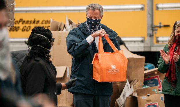 NEW YORK, NY - APRIL 14: New York City Mayor Bill de Blasio holds a bag of produce packed at a food...