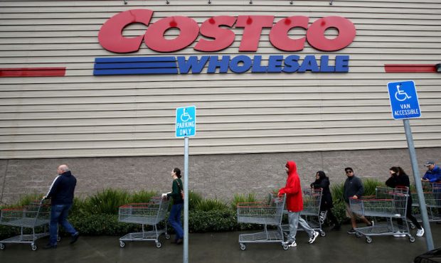 Customers wait in line to enter a Costco store on March 14, 2020 (Photo by Justin Sullivan/Getty Im...