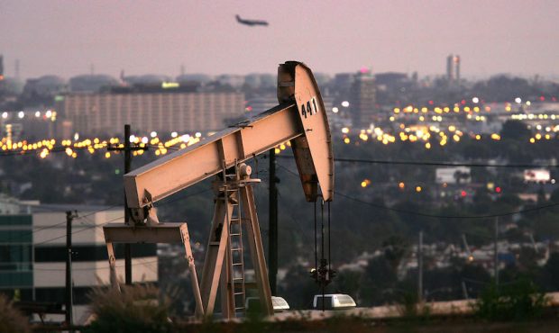 FILE: A jet lands at Los Angeles International Airport (LAX) as oil rigs extract petroleum. (Photo ...