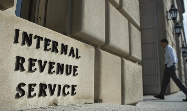FILE: A man walks into the Internal Revenue Service building in Washington, DC on March 10, 2016. (...