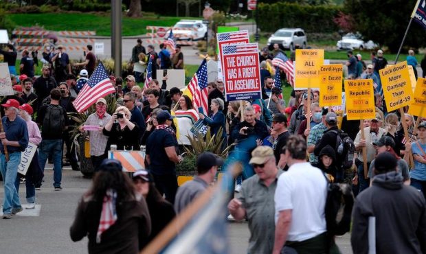 Hundreds of protesters gather around the Capitol in Olympia, Wash., on April 19, 2020, to demonstra...