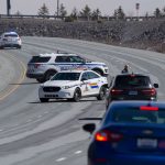 Police block the highway in Enfield, Nova Scotia on Sunday, April 19, 2020. Canadian police on Sunday arrested a suspect in an active shooter investigation after earlier saying he may have been driving a vehicle resembling a police car and wearing a police uniform.  (Andrew Vaughan/The Canadian Press via AP)