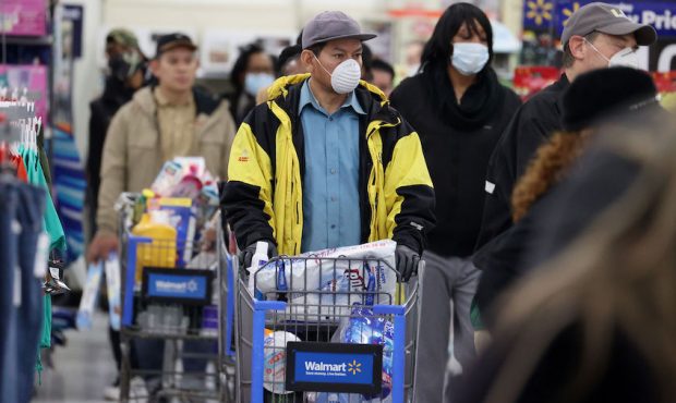 UNIONDALE, NEW YORK - APRIL 03: People wearing masks and gloves wait to checkout at Walmart on Apri...