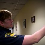 Captain Lyndsie Hauck points at one of the pictures she hung at the South Salt Lake Fire Department.