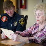 Joyce Hicks reads an affidavit written by her mother at the South Salt Lake Fire Department.