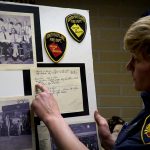 Captain Lyndsie Hauck shows a poster board that allowed them to "put a face to the name," which she uncovered in the Records Room.