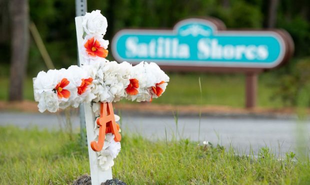 A cross with flowers and a letter "A" sits at the entrance to the Satilla Shores neighborhood where...