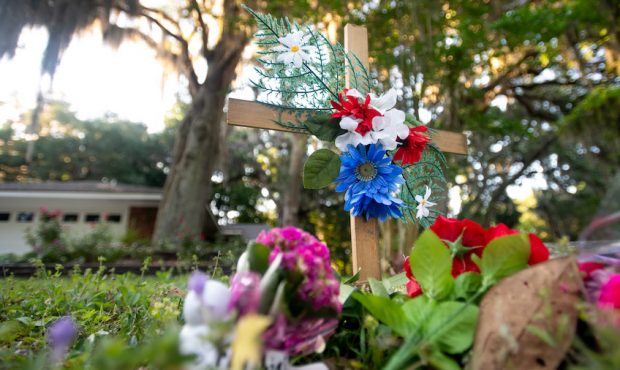 BRUNSWICK, GA - MAY 07: A cross with flowers sits near the intersection of Satilla Rd. and Holmes R...