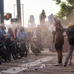 MINNEAPOLIS, MN - MAY 27: Protesters are shot with pepper spray as they confront police outside the Third Police Precinct on May 27, 2020 in Minneapolis, Minnesota. The station has become the site of an ongoing protest after the police killing of George Floyd. Four Minneapolis police officers have been fired after a video taken by a bystander was posted on social media showing Floyd's neck being pinned to the ground by an officer as he repeatedly said, "I can’t breathe". Floyd was later pronounced dead while in police custody after being transported to Hennepin County Medical Center.  (Photo by Stephen Maturen/Getty Images)