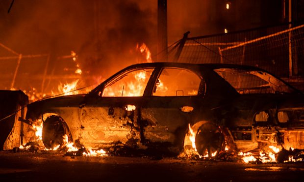 MINNEAPOLIS, MN - MAY 27: A car burns near the Third Police Precinct on May 27, 2020 in Minneapolis...