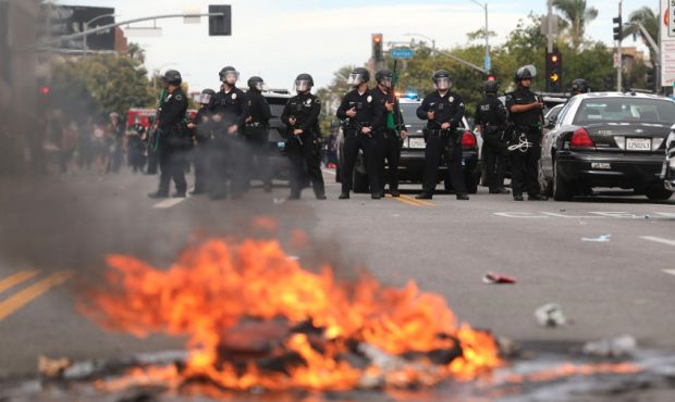 LAPD officers keep watch by a small fire set during demonstrations following the death of George Fl...