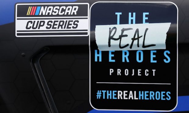 A decal bearing the name of the Real Heroes 400 NASCAR Cup Series auto race is displayed on the car...
