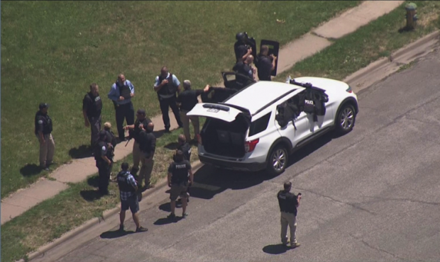 Authorities respond to an Ogden neighborhood Thursday after an officer-involved shooting. (KSL TV)...
