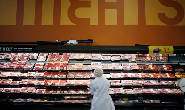 An employee restocks shelves with pork in the meat section at a Kroger Co. supermarket in Louisvill...