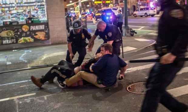 Police arrest a protester near Times Square after an 11pm curfew during a night of marches and vand...