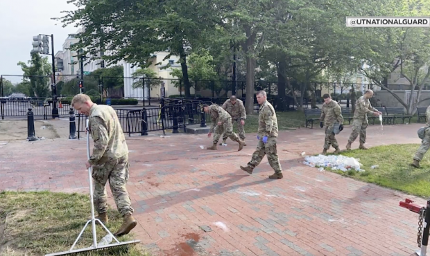 Members of the Utah National Guard clean the streets of Washington D.C. after protests....