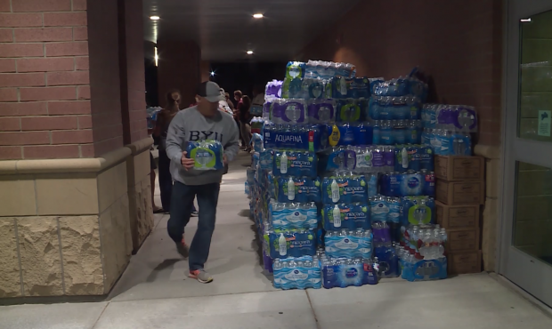 Volunteers stock Westlake High School in Saratoga Springs with supplies for residents evacuated due...