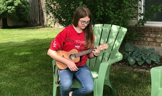 With summer camps closed, Ellie Maher plays her ukulele daily to keep busy....