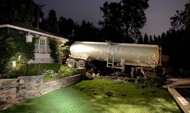An asphalt oil tanker crashed into the back yard of a Salt Lake City residence on July 8, 2020. (Ph...
