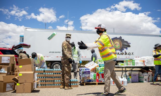 HUERFANO, NM - MAY 27: Navajo Nation President Jonathan Nez helps distribute food, water, and other...